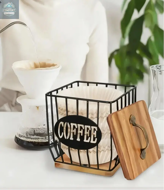 Coffee filter holder and capsule basket with wood lid displayed on coffee bar beside pour over coffee maker
