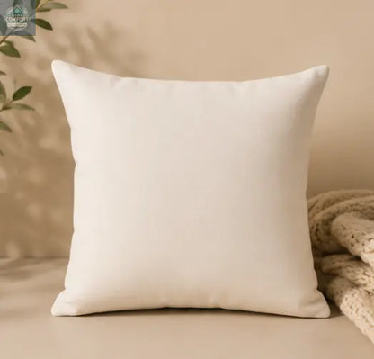 Cozy Nights Square Throw Pillow on a beige background with a textured blanket and plant leaves.