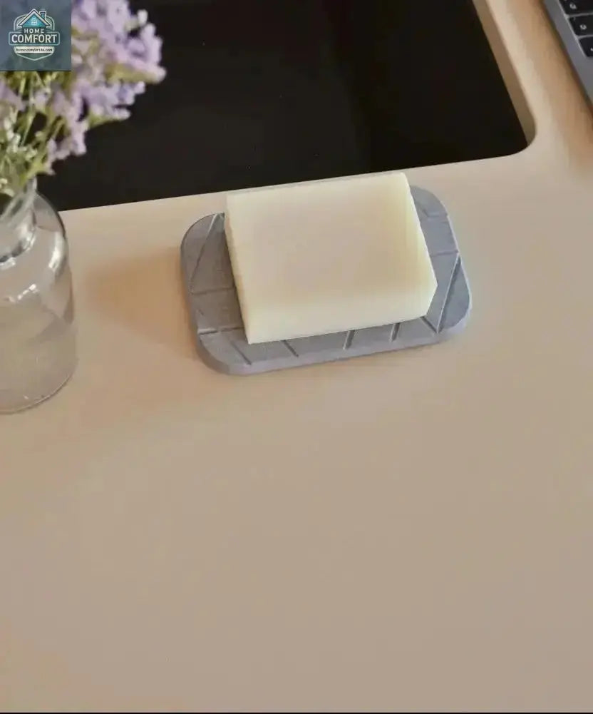 Modern geometric diatomite soap dish with bar soap placed beside bathroom sink