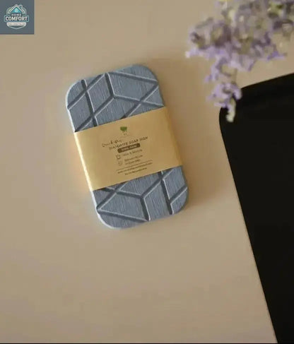 Geometric quick-dry diatomite soap dish displayed with kraft packaging on countertop
