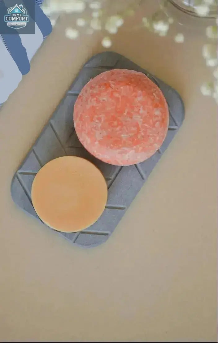 Quick-drying geometric diatomite soap dish holding two bar soaps on bathroom surface