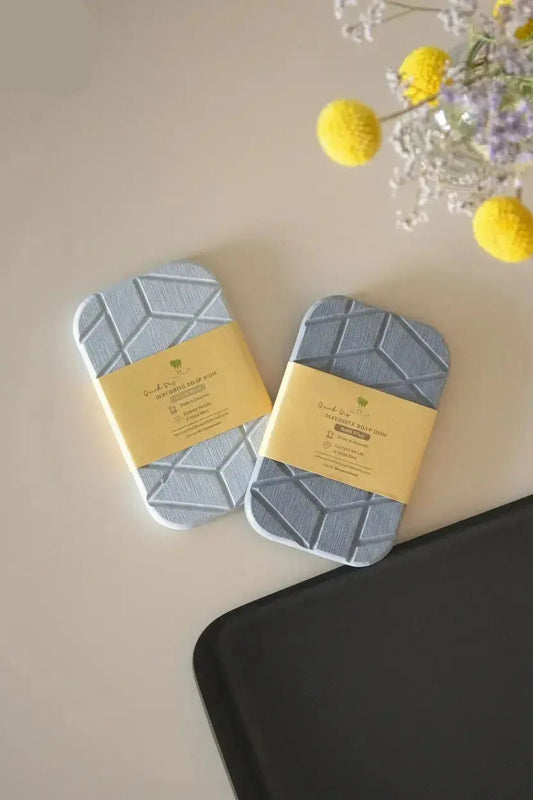 Geometric diatomite soap dish with quick-dry stone material shown packaged on bathroom counter