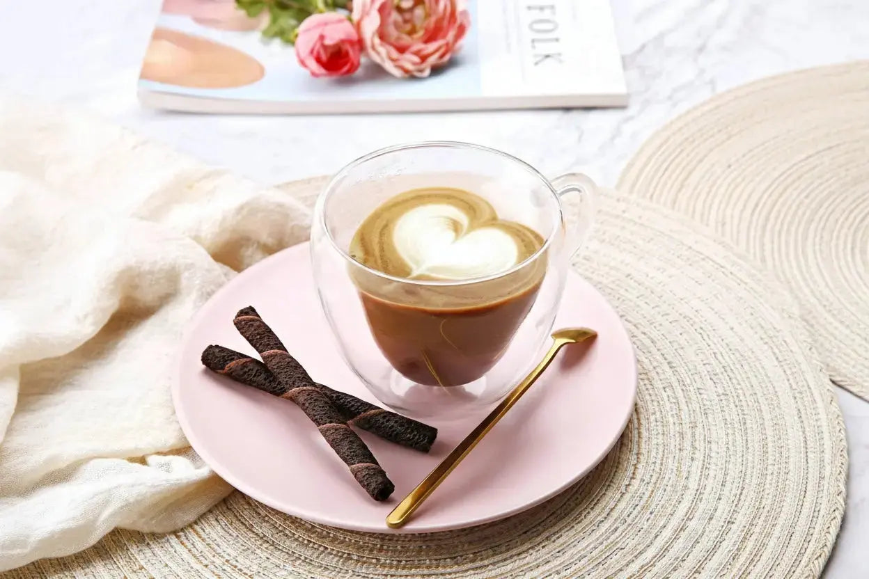 Top view of double wall heart-shaped glass mugs filled with coffee showing insulated borosilicate glass design
