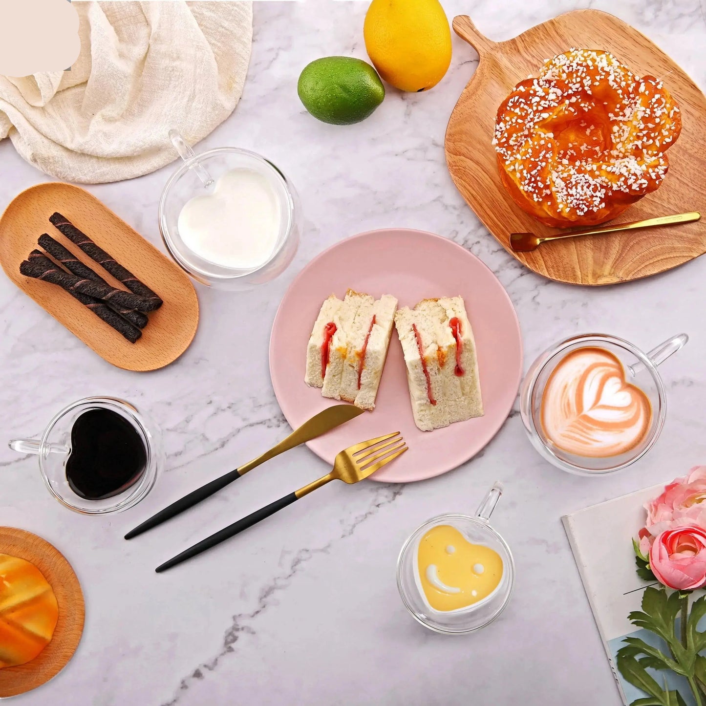 Double wall heart shaped glass mug with coffee on breakfast table lifestyle scene