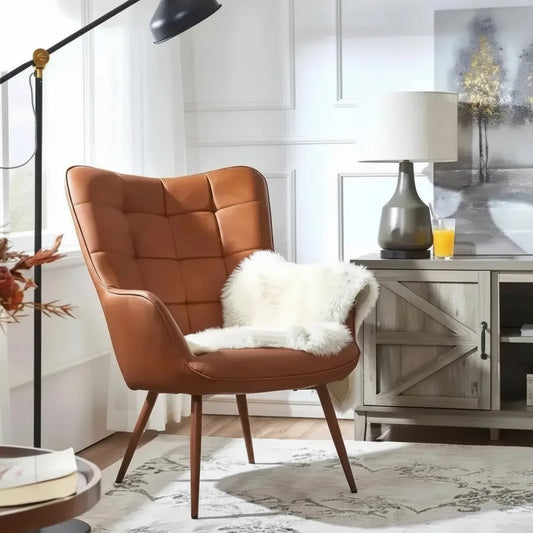 Brown faux leather wingback accent chair placed in a living room beside a floor lamp and cabinet