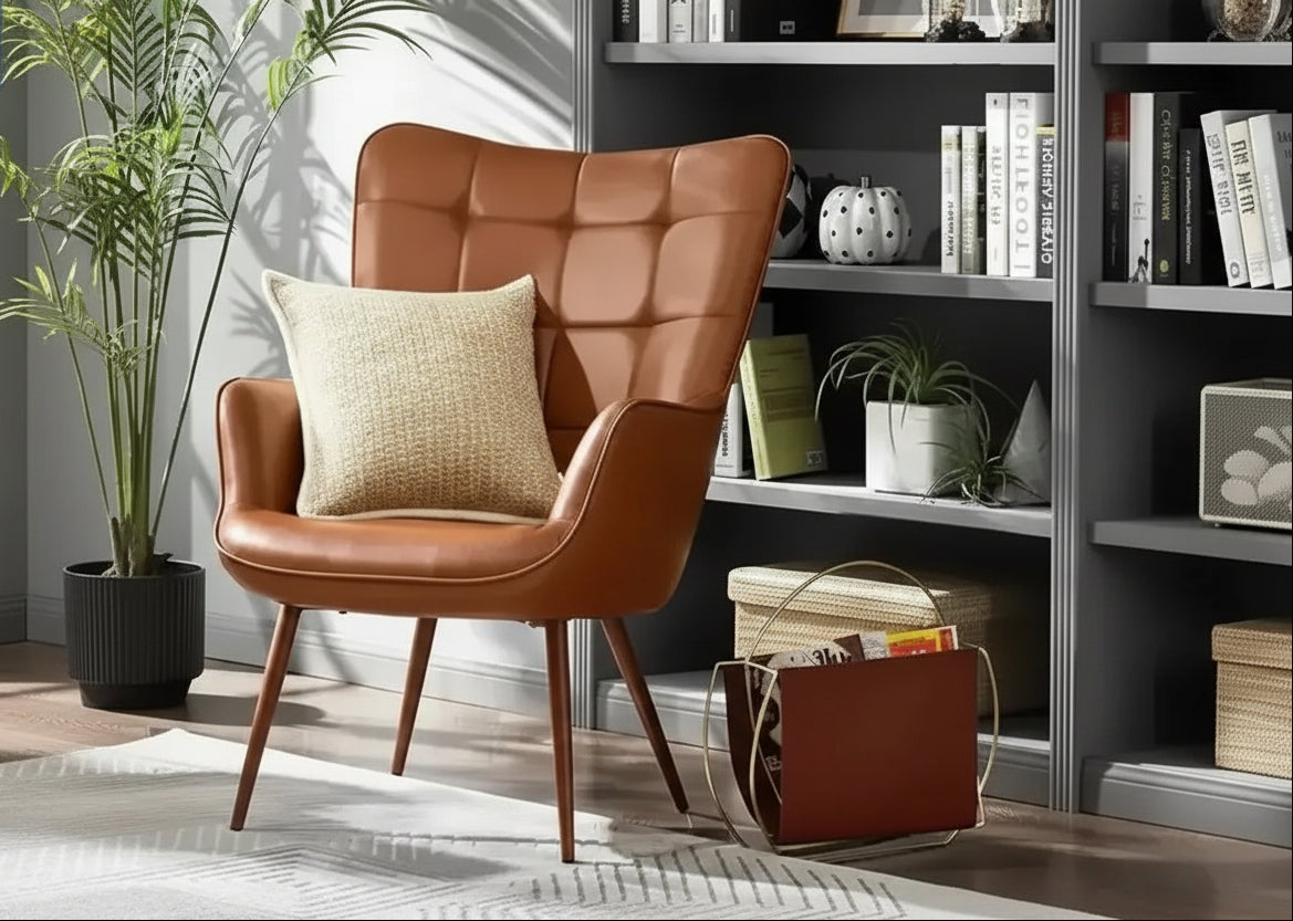 Brown faux leather wingback accent chair styled in a reading room with bookshelf background