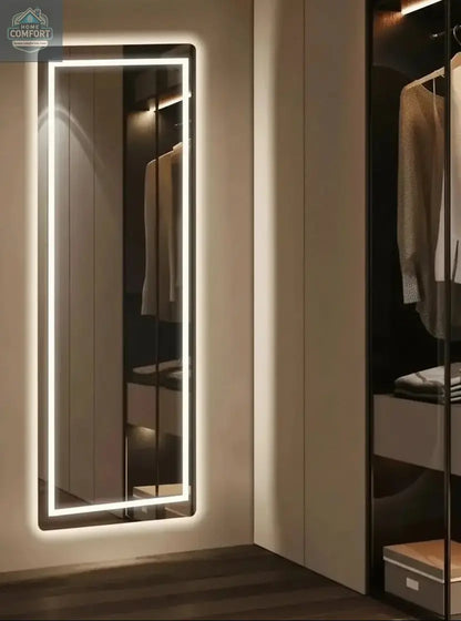 Full length LED mirror positioned near closet showing illuminated frame and full body reflection
