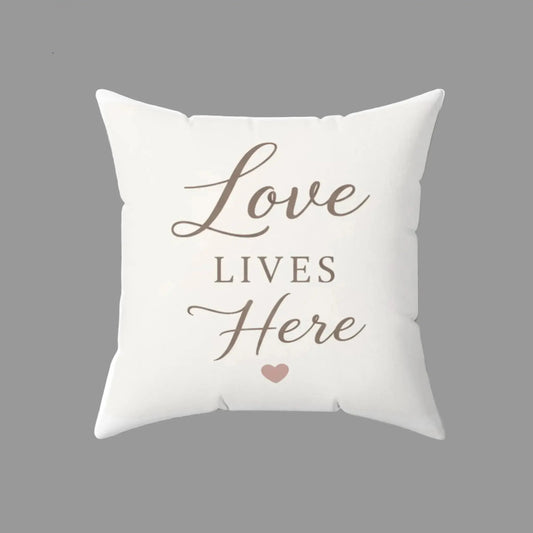 Cream farmhouse square throw pillow with Love Lives Here text design for cozy home decor
