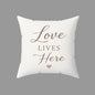Cream farmhouse square throw pillow with Love Lives Here text design for cozy home decor