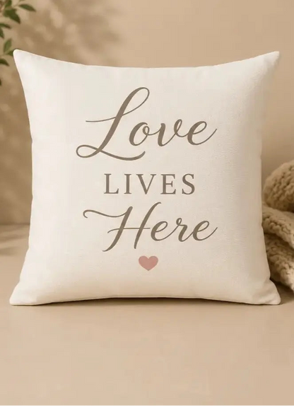 Decorative pillow with 'Love Lives Here' text on a beige background