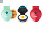 Three compact mini waffle makers in different colors displayed on a white background with one open showing cooking surface.