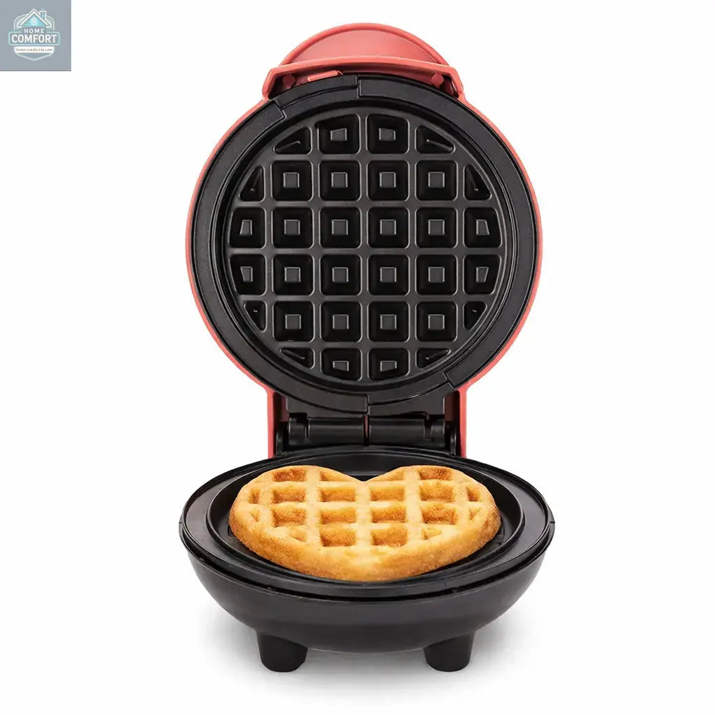 Compact mini waffle maker open with freshly cooked waffle inside on a clean white background.