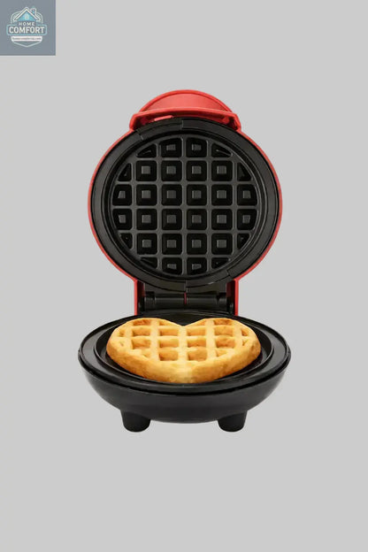 Compact mini waffle maker open with freshly cooked waffle inside on a clean white background.