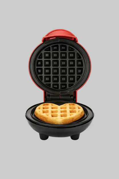 Compact mini waffle maker open with freshly cooked waffle inside on a clean white background.