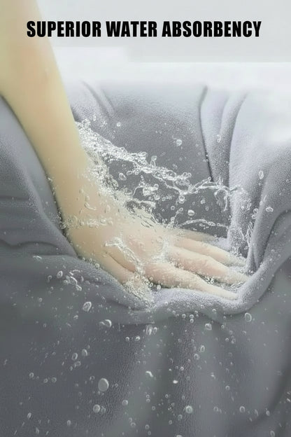 Oversized Bath Towel set Hand touching gray fabric with water droplets, emphasizing superior water absorbency.