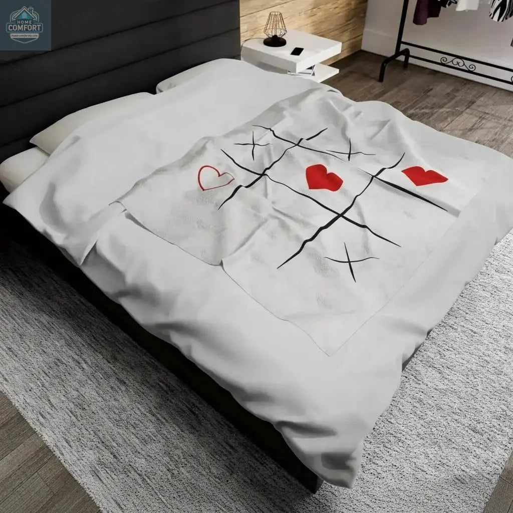 Personalized velveteen plush blanket spread across a bed in a modern bedroom showing soft fabric and custom printed design