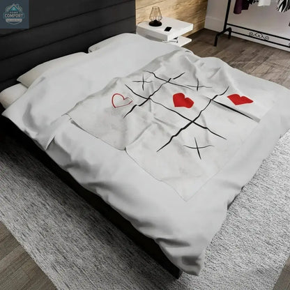 Personalized velveteen plush blanket spread across a bed in a modern bedroom showing soft fabric and custom printed design