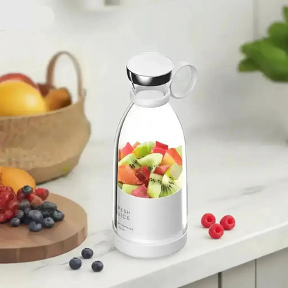 Portable personal mini blender cup with fresh fruit on kitchen counter for smoothies and juice