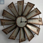 Antique metal windmill wall clock with distressed blades and Roman numeral style center, rustic farmhouse wall decor